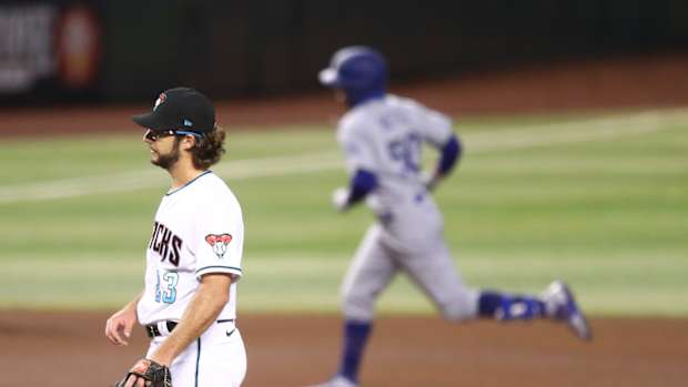 Jul 31, 2020; Phoenix, Arizona, USA; Arizona Diamondbacks pitcher Zac Gallen (left) reacts after giving up a home run to Los Angeles Dodgers outfielder Mookie Betts in the fourth inning at Chase Field. Mandatory Credit: Mark J. Rebilas-USA TODAY Sports